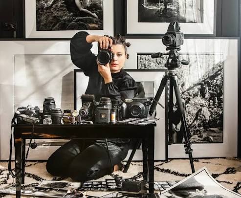 Javiera Estrada behind the camera in her photography studio